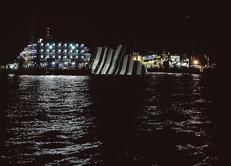 The Costa Concordia cruise ship lies on its side Sunday as relatives of the victims commemorate the 32 people who died in the shipwreck in the Tuscan Island Isola del Giglio, Italy.