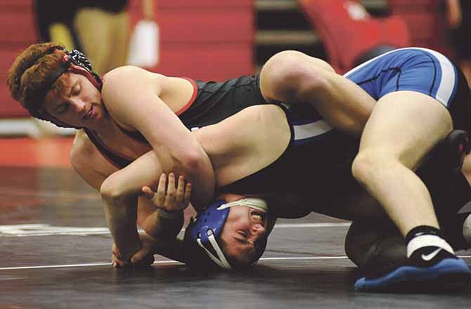 Zach Eggen of Jefferson City applies pressure to the arm of Jacob Bender from Northwest in a 195-pound semifinal matchup Saturday in the Capital City Wrestling Invitational at Fleming Fieldhouse.