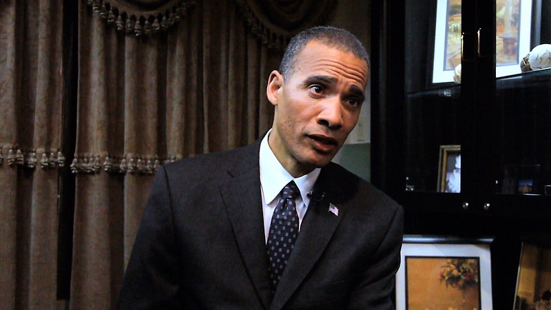 In this image from video, President Barack Obama lookalike Larry Graves speaks during an interview. Graves has the security detail, the prominent ears and the U.S. flag pin, but substitute teacher Graves is no Barack Obama. He's a professional lookalike for the president. They have something else in common, too: a frantic schedule leading up to the inauguration.