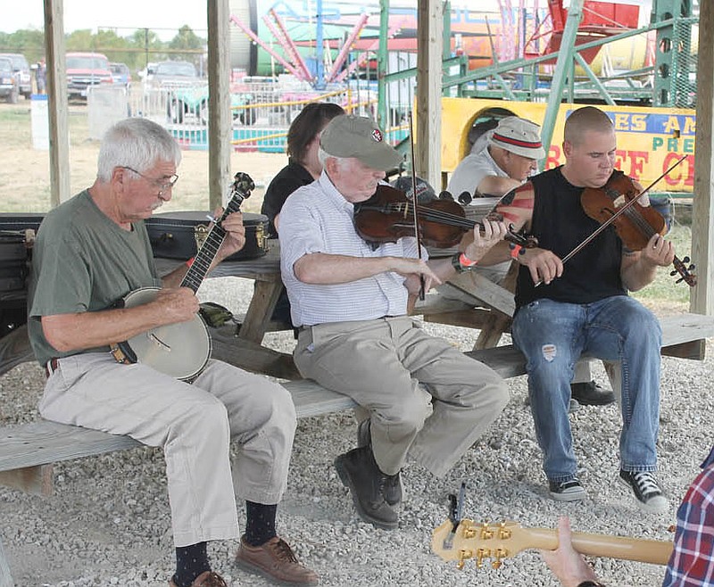 Howard Marshall (center) of Fulton, warms up for the old time fiddling contest at the 2012 Kingdom of Callaway County Fair. Marshall, who has been playing for 40 years, recently published a book on the history of fiddle music in Missouri, "Play Me Something Quick and Devilish."