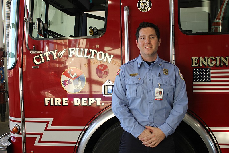 Michael Bainbridge poses with an engine at the Tennyson station Monday. Bainbridge was recently named the Firefighter of the Year by the Fulton Professional Firefighters Union.