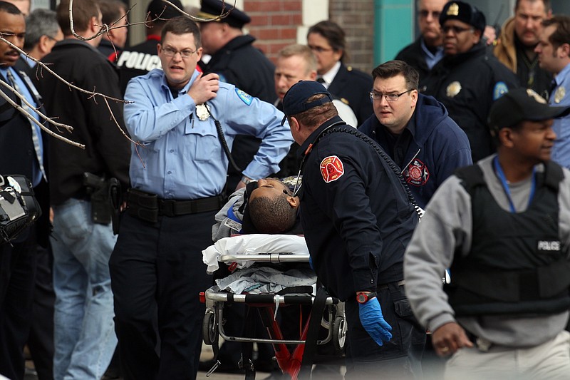 Police and emergency personal respond Tuesday to a shooting victim at Stevens Institute of Business and Arts in St. Louis. Police say a gunman entered the school and shot a person in the chest, then shot himself.