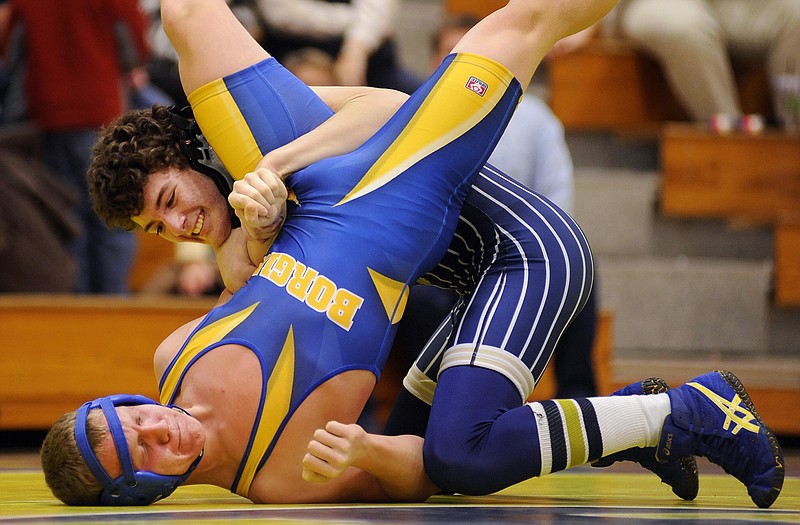 Austin Schnieders of Helias rolls Borgia's Dylan Voss onto his shoulders moments before winning the 145-pound match by fall during Wednesday night's dual at Rackers Fieldhouse.