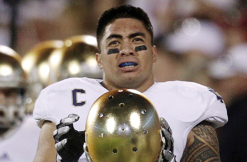 In this Oct. 27, 2012, file photo, Notre Dame linebacker Manti Te'o stands on the sidelines during a game against Oklahoma in Norman, Okla. Notre Dame issued a release Wednesday saying a story about Te'o's girlfriend dying, which he said inspired him to play better as he helped the Fighting Irish get to the BCS title game, turned out to be a hoax apparently perpetrated against the linebacker.