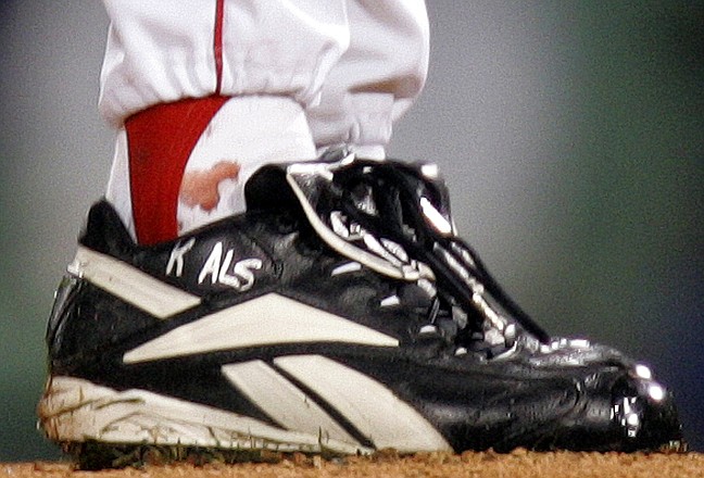 Blood appears around the right ankle of Boston Red Sox pitcher Curt Schilling during the sixth inning of Game 2 of the 2004 World Series against the St. Louis Cardinals in Boston. Schilling is selling the sock.