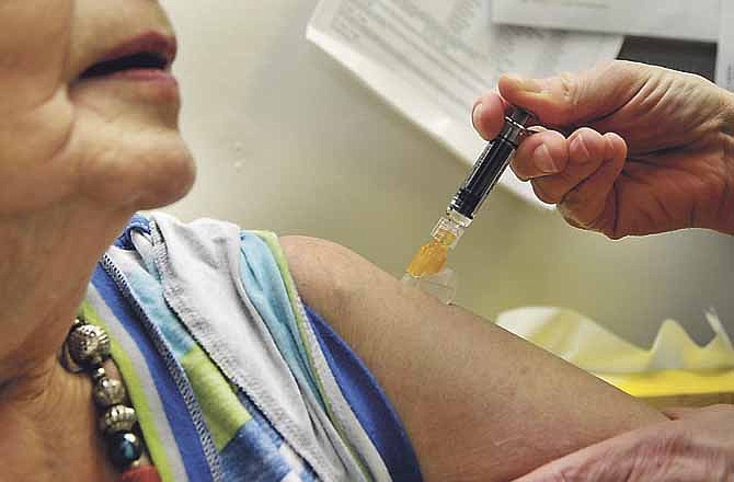 Donna Seidel, RN, administers a flu shot to Donna Hildebrand on Wednesday at the Cole County Health Department. It just received a new supply of the flu vaccine and were dispensing them as needed.