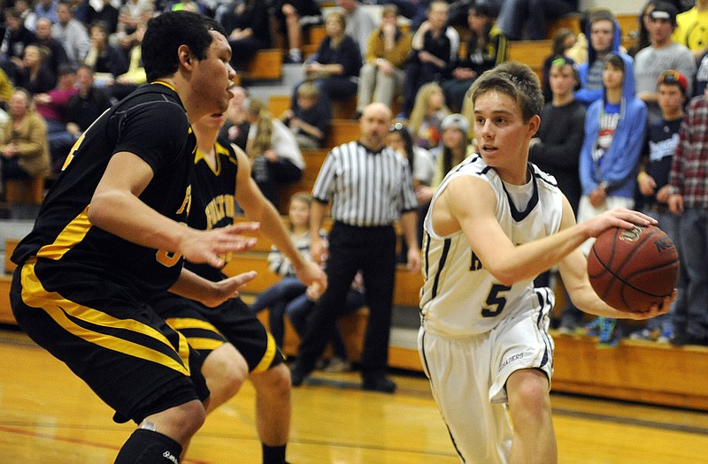 Helias guard Brock Gerstner looks to make a pass along the baseline against Fulton on Friday night at Rackers Fieldhouse.