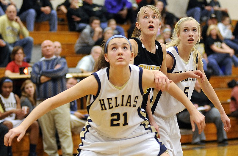 Helias center Mai Nienhueser boxes out during Friday night's matchup against Fulton at Rackers Fieldhouse.