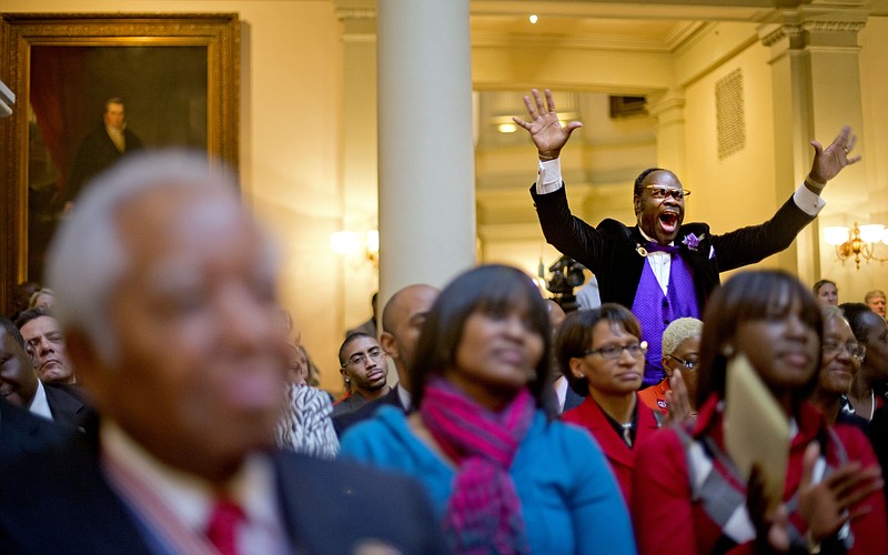 Elder Cal Murrell, also known as "the happy preacher," reacts Thursday during a service celebrating the Rev. Martin Luther King Jr., inside the State Capitol in Atlanta.