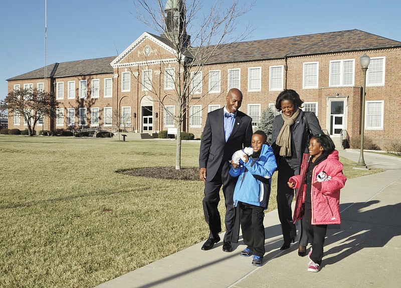 Kevin Rome Jr., 7, and his twin sister, Kendell, are excited about their Blue Tiger mascot stuffed animals and their dad's new job. Kevin D. Rome, seen here with his wife, Stefanie, was named the new President of Lincoln University in a brief press conference Friday morning. 