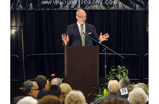 St. Raymond's Society co-founder Steve Smith addresses the capacity crowd in the Grand Ballroom during the Midwest March for Life Benefit Banquet at the Capitol Plaza Hotel on Friday.