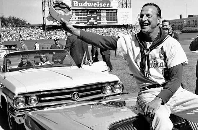 In this Sept. 29, 1963 file photo, St. Louis Cardinals' Stan Musial waves to fans during ceremonies marking the his last game as a player before a baseball game against the Cincinnati Reds in St. Louis. Musial, one of baseball's greatest hitters and a Hall of Famer with the Cardinals for more than two decades, died Saturday, Jan. 19, 2013, the team announced. He was 92.