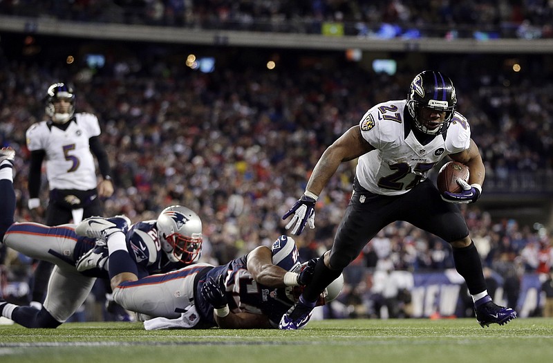 Ravens running back Ray Rice heads on his way for a two-yard touchdown run after eluding Patriots outside linebacker Dont'a Hightower (54) in the first half of Sunday's AFC Championship game in Foxborough, Mass.