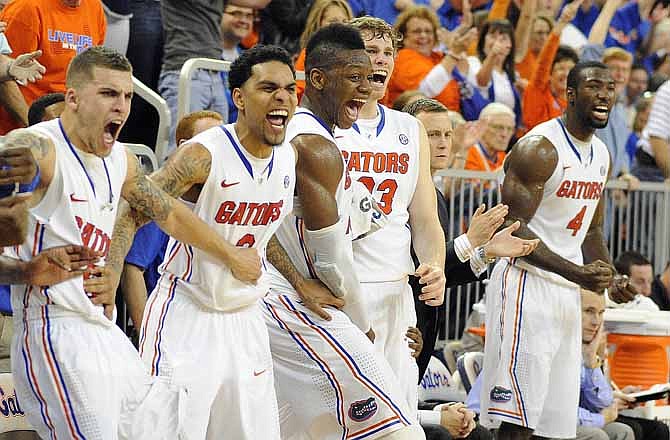 Florida players from left, Scottie Wilbekin, Mike Rosario, Will Yeguete, Erick Murphy and Patric Young celebrate a basket during the second half of an NCAA college basketball game against Missouri in Gainesville, Fla., Saturday, Jan. 19, 2013. Florida defeated Missouri 83-52.