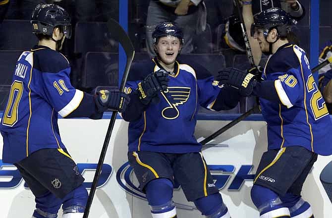 St. Louis Blues' Vladimir Tarasenko, of Russia, is congratulated by teammates Andy McDonald, left, and Alexander Steen, right, after scoring his second goal of the game during the second period of an NHL hockey game against the Detroit Red Wings Saturday, Jan. 19, 2013, in St. Louis.