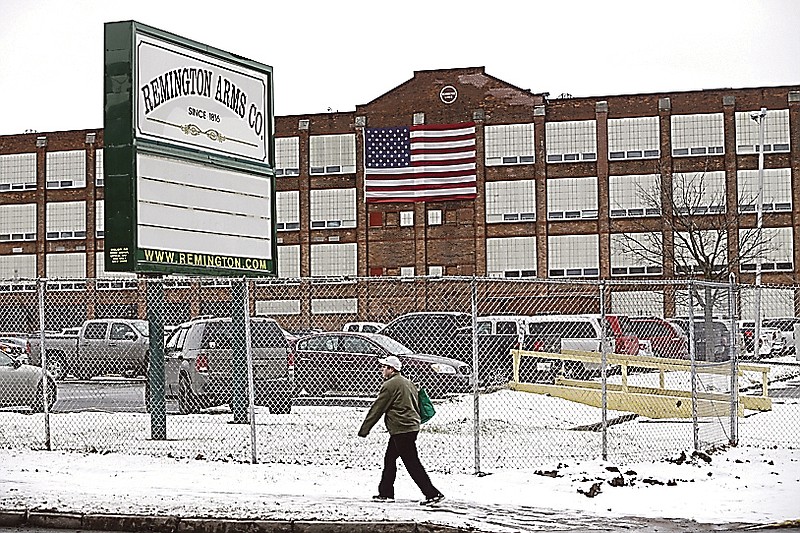 A man walks past the Remington Arms Company in Ilion, N.Y.