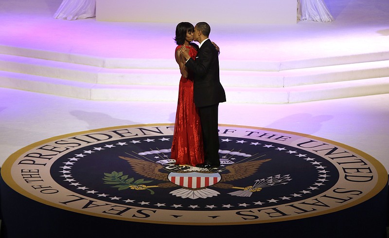 President Barack Obama and first lady Michelle Obama kiss as they dance during the Commander-In-Chief inaugural ball at the Washington Convention Center during the 57th Presidential Inauguration on Monday in Washington. 