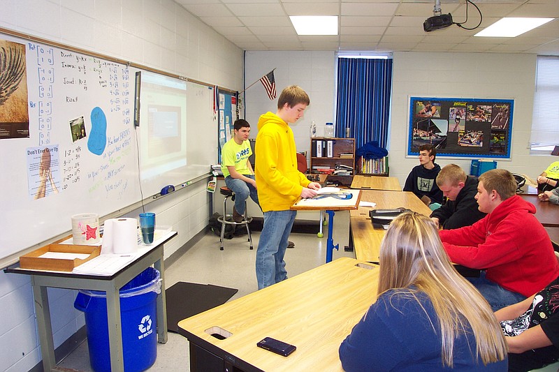 Jacob Robertson, standing, and Alex Thompson, left, Character Council members at Russellville High School, recently led a Tribe Time discussion on the dangers and second-hand effects of substance abuse.