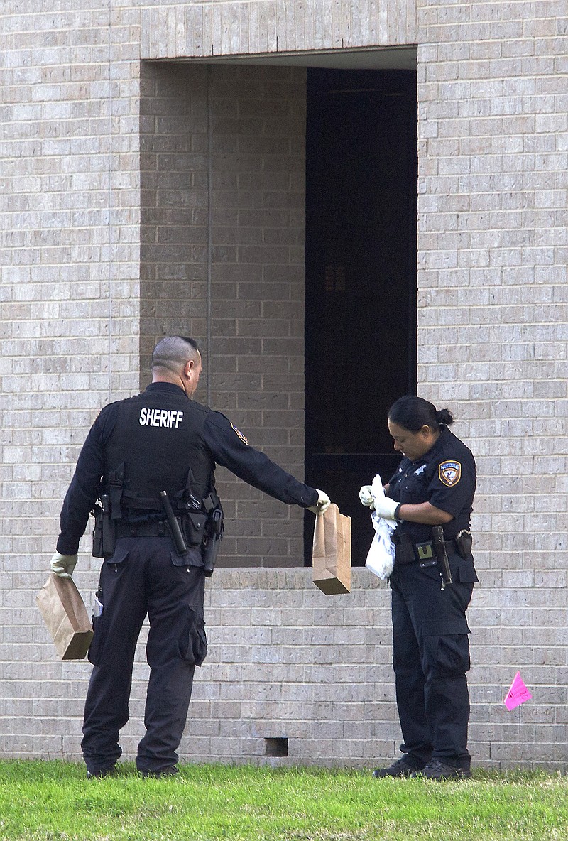 Police collect evidence Tuesday after a shooting on Lone Star College North Harris campus. 