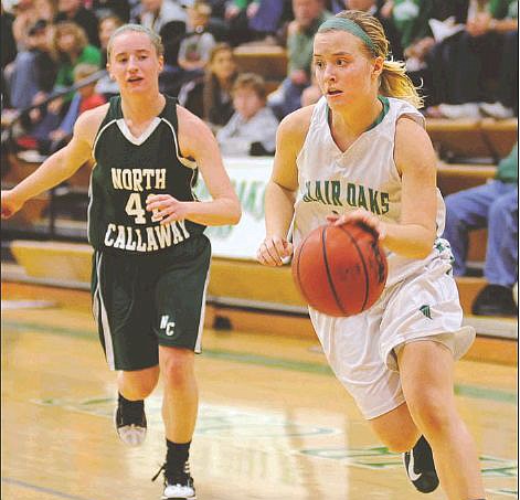 Blair Oaks guard Sara Jones looks for an open lane to the basket after dribbling past North Callaway's Elaine Brinker during Monday night's game in Wardsville.