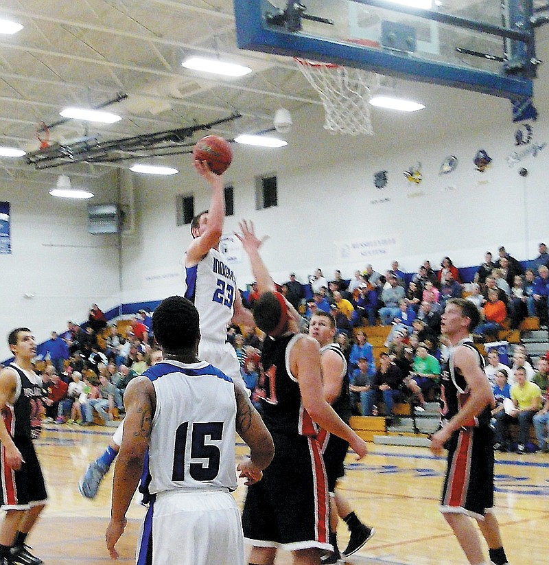 Russellville's Chandler Wolf (23) puts up a shot during the varsity game against Prairie Home Friday night at Russellville.