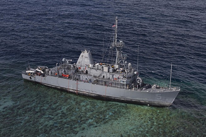 The USS Guardian sits aground Tuesday on the Tubbataha Reef in the Sulu Sea in the Philippines. Operations to safely recover the ship while minimizing environmental effects are being conducted in close cooperation with allied Philippines Coast Guard and Navy. 