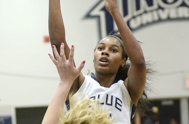 Lincoln's Dahlia Booker puts up a jumper over Washburn's Laura McMullin in Thursday's game at Jason Gym.