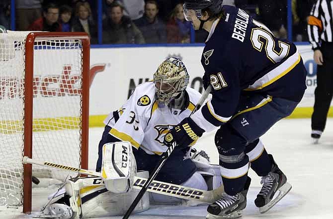 St. Louis Blues' Patrik Berglund, right, of Sweden, scores on a penalty shot past Nashville Predators goalie Pekka Rinne, left, of Finland, during the second period of an NHL hockey game on Thursday, Jan. 24, 2013, in St. Louis. 