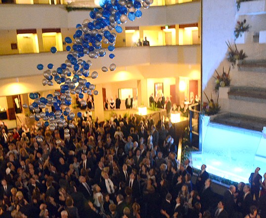 Hundreds of balloons, some containing valuable prizes, fall from the ceiling of the Capitol Plaza Hotel on top of those attending the 2013 Chamber Gala.