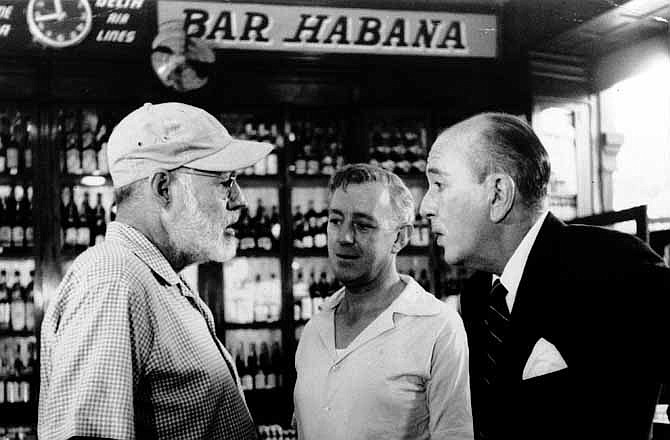 In this May 12, 1959, American novelist Ernest Hemingway, left, speaks with actors Alec Guinness, center, and Noel Coward in Sloppy Joe's Bar during the making of Sir Carol Reed's film version of "Our Man in Havana," based on Graham Greene's best seller, in Havana, Cuba. Sloppy Joe's will be reopened in February 2013 by the state-owned tourism company Habaguanex, part of an ambitious revitalization project by the Havana City Historian's Office, which since the 1990's has transformed block after block of crumbling ruins into rehabilitated buildings along vibrant cobblestone streets, giving residents and tourists from all over the chance to belly up to the same bar that served thirsty celebrities like Rock Hudson, Babe Ruth and Ernest Hemingway. 