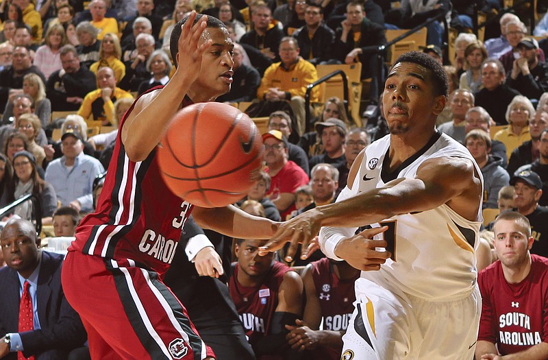 Missouri guard Phil Pressey fires a pass along the baseline while being defended by South Carolina guard Damien Leonard during Tuesday's game. Missouri hosts Vanderbilt today.