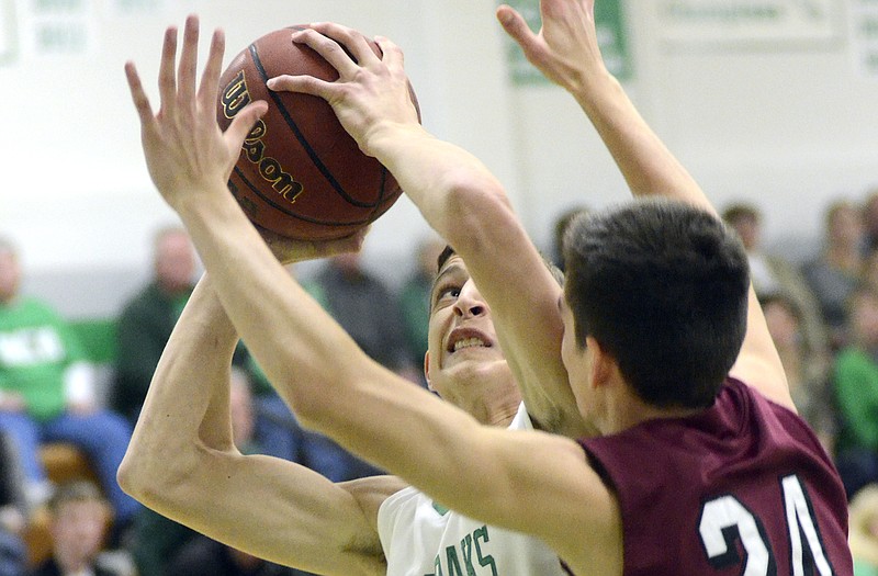 Blair Oaks' Ryan Wilbers tries to shoot around Linn's Jedd Oidtman during Friday's game in Wardsville. Blair Oaks won 59-49.