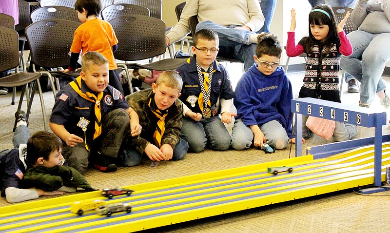 Fulton youngsters root for their car to win Saturday during the Bartley Elementary School Cub Scout Pack 52 Pinewood Derby competition in the Civic Meeting Room at the Callaway Electric Cooperative. The event is sponsored by the Fulton Breakfast Optimist Club.