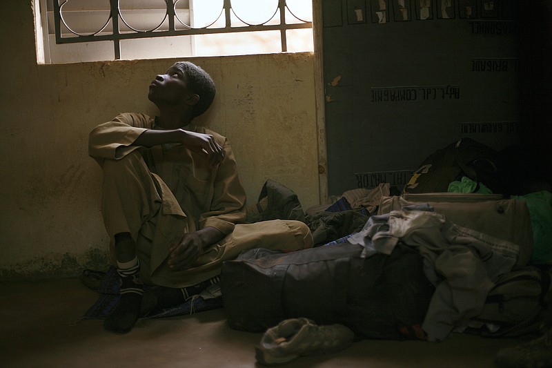 Adama Drabo, 16, sits in the police station in Sevare, some 620 kilometers (385 miles) north of Mali's capital Bamako Friday, Jan. 25, 2013. Drabo, who said he was captured travelling without papers by Malian troops and eventually handed over to Gendarmes in Sevare, was arrested on suspicion of working for Islamic militant group MUJAO and caught trying to flee south, Police said. A farmer's son from Niono, he admitted to having worked in the kitchens of a jihadist training base in Douentza for the past month. Drabo said his only motivation in joining the Islamic militant group had been to earn a wage, having struggled to find work at home, and that he was one of the youngest recruits on the base. 