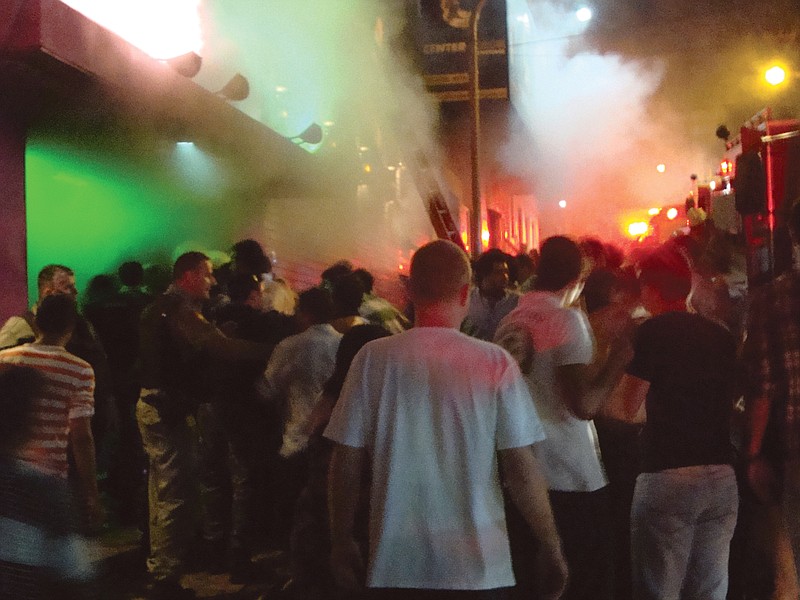 A crowd stands outside the Kiss nightclub during a fire inside the club in Santa Maria, Brazil. A blaze raced through the crowded nightclub in southern Brazil early Sunday, killing at least 230 people as the air filled with deadly smoke and panicked party-goers stampeded toward the exits.