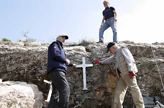 Members of a group of retired Italians resurrect a cross made from remnants from a World War II aircraft that crashed at the base of Mount Tezio near their hometown of Perugia. The group has been researching the crash and is trying to find relatives of the six American soldiers who died in the crash. 