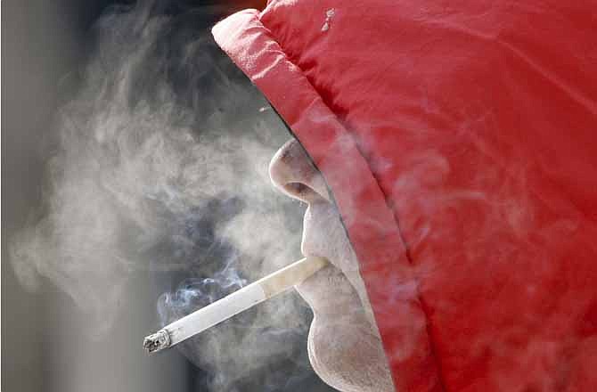 In this Wednesday, Feb. 14, 2007 file photo, a man smokes in Omaha, Neb.