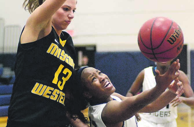 At 5-foot-6, Arriana Walker of Lincoln tries to find a way to shoot around 6-foot-3 Heather Howard of Missouri Western during Saturday's game at Jason Gym in Jefferson City.