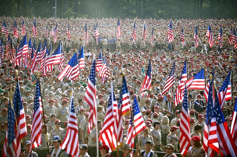 Thousands of Boy Scouts march with flags for the playing of the national anthem during the Boy Scouts of America's 2010 National Jamboree at Ft. AP Hill, Va. The Boy Scouts of America announced Monday that it was considering replacing its long-standing ban on gays with a policy that would let troop sponsors make their own decisions.