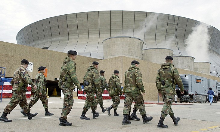 National Guardsmen patrol the Louisiana Superdome in New Orleans in 2002. It's an unprecedented security challenge for New Orleans: the city's increasingly raucous buildup to Mardi Gras gets suspended for a week as 150,000 visitors flood the town for Super Bowl. Joining the police department's 1,200-plus officers for Super Bowl week are more than 200 state troopers and about 100 officers from surrounding local jurisdictions. 