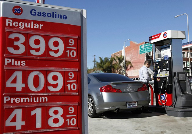 A man buys gas at a station Thursday in Los Angeles. Gasoline prices are climbing as rising economic growth boosts oil prices and temporary refinery outages crimp gasoline supplies on the East and West Coasts. 