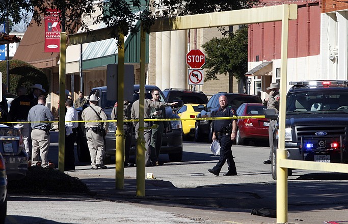 Law enforcement officers investigate the scene of a shooting in downtown Kaufman, Texas, on Thursday. A prosecutor was shot and killed near the courthouse where he worked. 