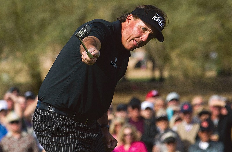 Phil Mickelson watches his birdie putt roll toward the cup during the first round of the Phoenix Open on Thursday. Mickelson needed to hit the putt to shoot a 59, but settled for a 60.