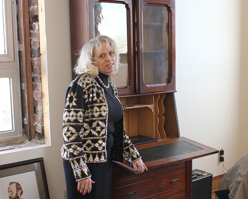 Deby Fitzpatrick shows off an antique Eastlake writing desk in her spacious office during a tour of B&N Accountings' new space, inside the former Bell Telephone building on 6th and Market streets Fitzpatrick moved the accounting firm into the building from their 5th street location, and has embraced the building's history, which still contains some original tile and other furnishings.