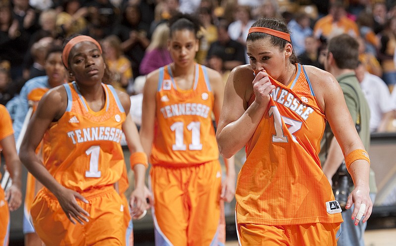 Tennessee's Taber Spani, right, wipes her face as she walks off the court with teammates Cierra Burdick, center, and Jasmine Phillips, left, after they were upset by Missouri 80-63 in an NCAA college basketball game on Sunday, Feb. 3, 2013, in Columbia, Mo. Missouri won the game 80-63.