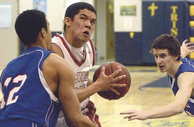 Loren Schlichting of Calvary Lutheran drives Saturday against the defense of Gerhard Von Zur Muehlen of St. Paul Lutheran.