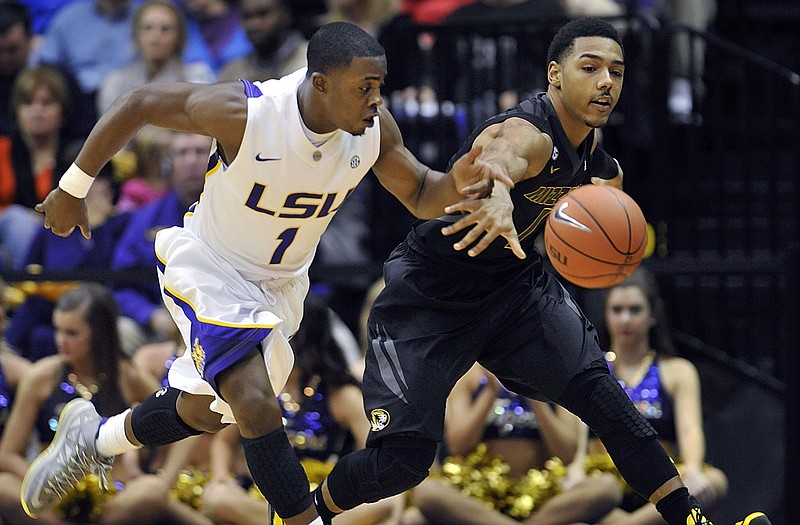 Phil Pressey of Missouri and Anthony Hickey of LSU chase after a loose ball during last Wednesday's game in Baton Rouge, La.