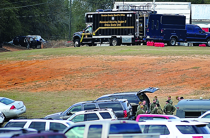 Armed law enforcement personnel station themselves near the property of Jimmy Lee Sykes before storming his bunker.