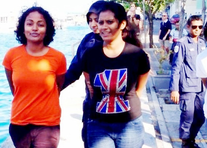 Shauna Aminath, left, a 2008 graduate of Westminster College in Fulton, and another unidentified woman were arrested Friday during an anti-government demonstration by a Maldive policewoman.