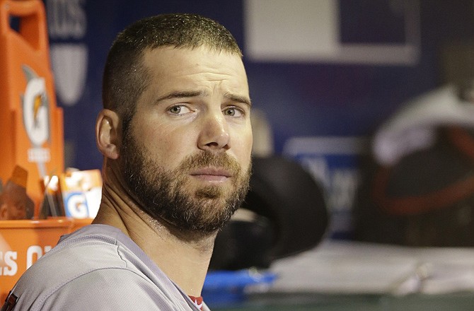 Cardinals pitcher Chris Carpenter sits in the dugout after being taken out of Game 2 of the NLCS against the Giants last October in San Francisco.